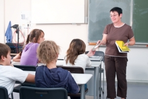 Teacher in classroom with children at desks