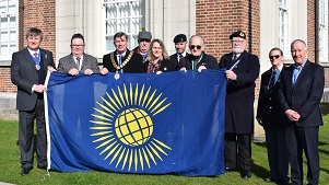 Chairman Councillor Jeff Bray and vice-chairman Councillor Peter Harris with others holding the Commonwealth Flag